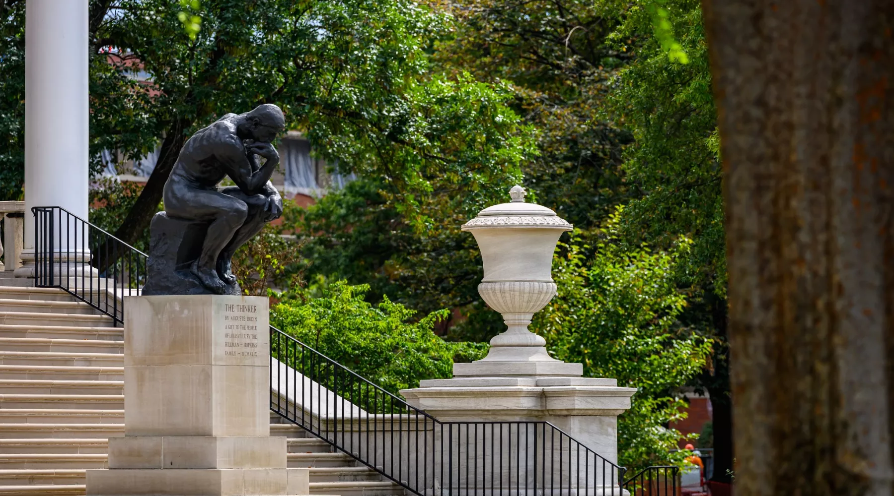 Side profile of The Thinker statue from a distance