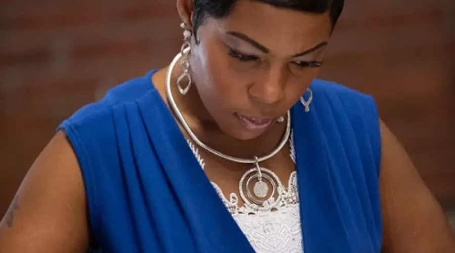 Woman wearing blue blouse looking at papers
