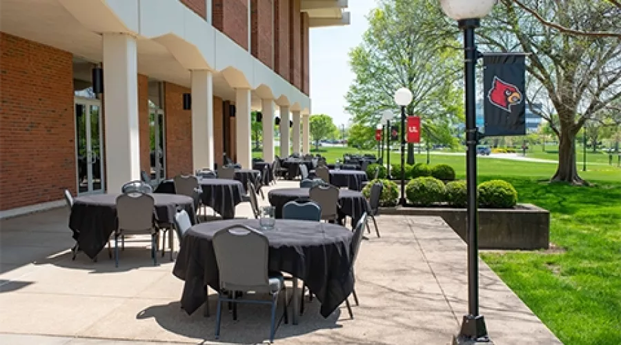 Outdoor seating area with round tables outside Founders Union