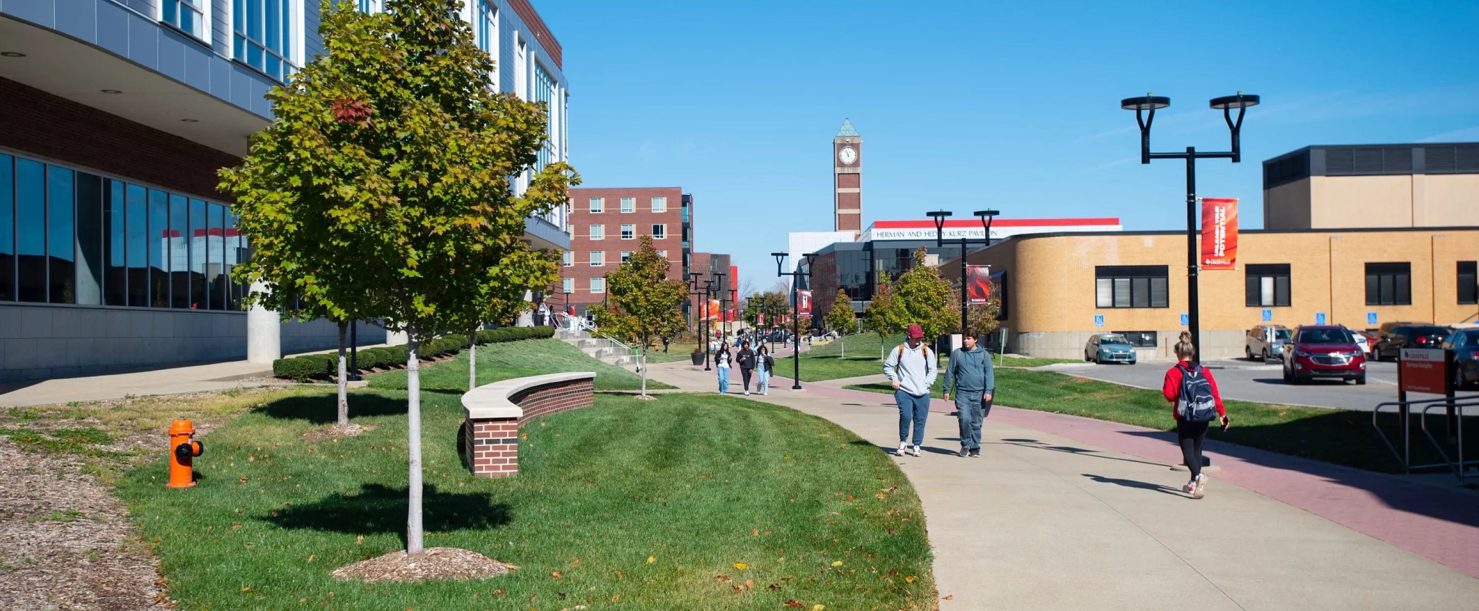 Students walking next to the Belknap Academics Building in the fall.