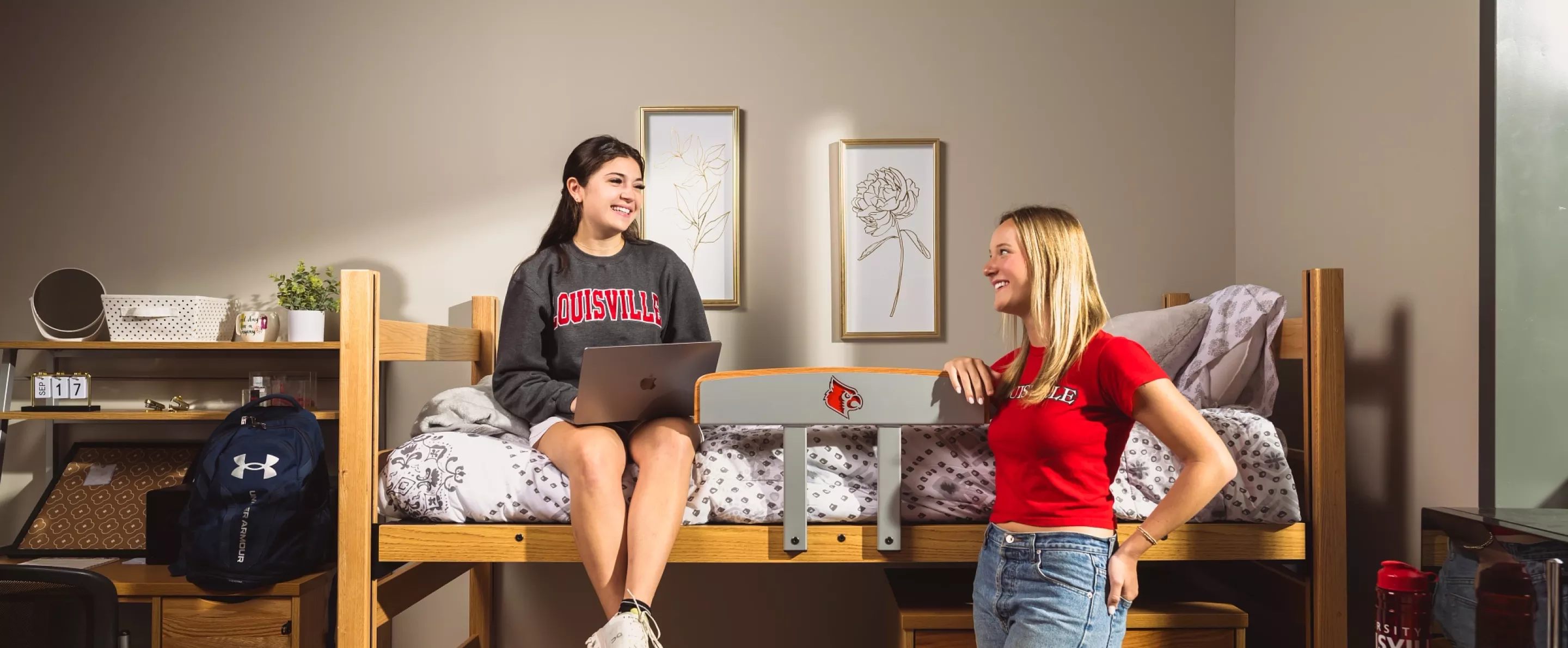 Two UofL students talking in a dorm room on campus