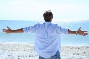 man looking at the ocean