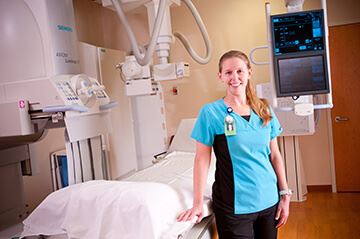 nurse by a hospital bed