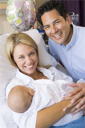 woman and a man with a new baby