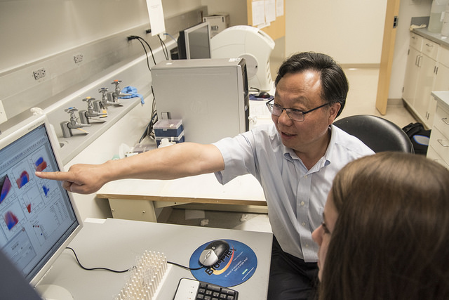 A teacher pointing at results on a computer