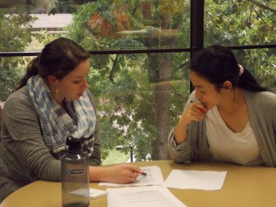 two women talking at table