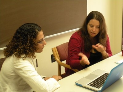 two women talking at table